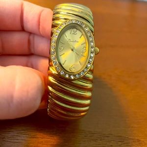 gold watch with gems around face